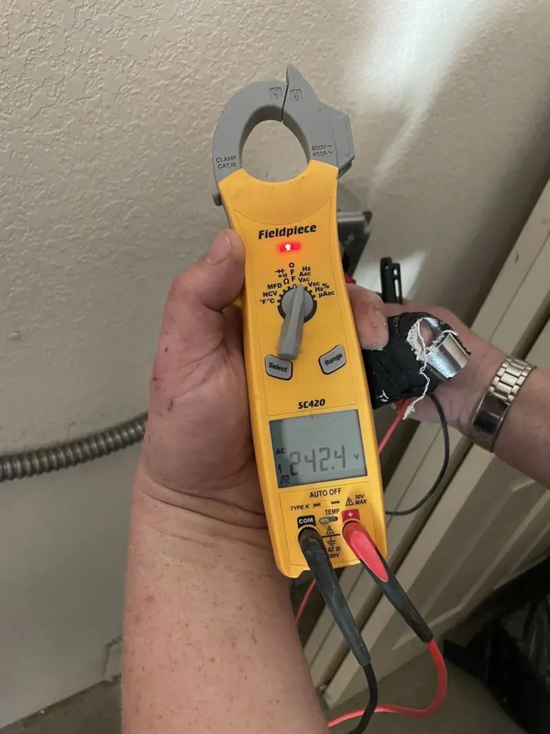 Voltage testing with clamp meter during Generator Installation in Mary Esther